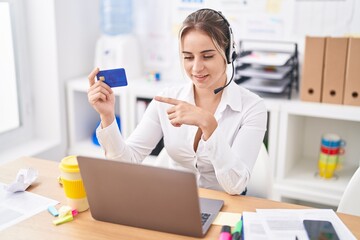 Canvas Print - Young blonde woman call center agent holding credit card working at office