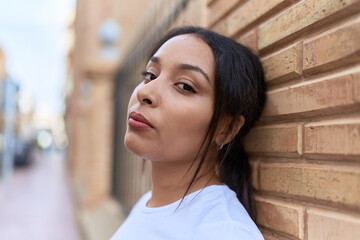 Wall Mural - Young arab woman standing with serious expression at street