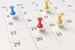 close-up of a calendar sheet and attached pushpins. concept for reminding or planning trips, important business meetings in the new year. 3d rendering