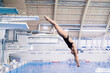 sportswoman in black suite dive into the swimming pool