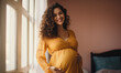Joyful pregnant Latina with a loving touch on her abdomen.