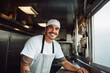 Latin American male chef preparing takeaway food in food truck kitchen