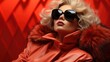 © tilialucida - A woman wearing sunglasses and a red coat.