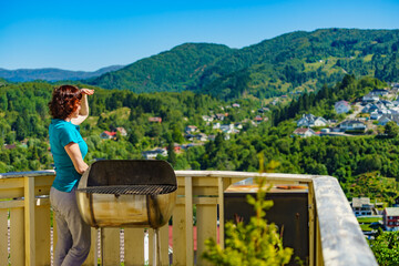 Poster - Woman on veranda enjoy norwegian landscape