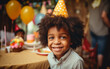 Portrait of cute african dark-skinned boy celebrating Birthday in cafe