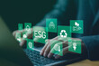 © somyuzu - man use computer to analyze ESG, ESG environment social governance investment business concept. ESG icons pop up on the computer screen in business investment strategy concept.