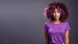© Ari - Afro american woman wearing purple t-shirt isolated on gray background