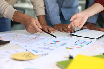 Sticker - Team of employees working with charts at table, closeup. Startup project