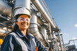 © MVProductions - A portrait of smiling female engineer at an oil refinery. Confidently overseeing operations, maintaining safety standards, and ensuring the efficient distillation of petroleum products