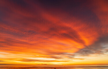 Wall Mural - abstract amazing scene of stuning colorful sunset or sunrise with clouds background in nature and tr