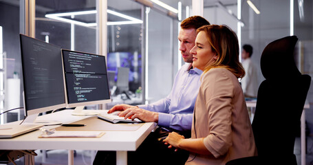 Computer Programmer Writing Program Code On Computer