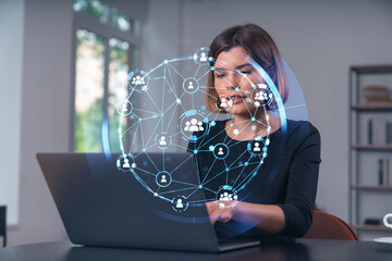 Wall Mural - Pensive attractive beautiful businesswoman in formal wear working on laptop at office workplace in background. Concept of network connection information technology.