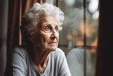 Fototapeta  - Depression, sad and senior woman by window looking, upset, lonely and unhappy in retirement home, Mental health, loneliness and and depressed elderly female thinking of problem, issues and crisis