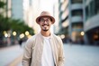 Portrait of a handsome asian man wearing hat and glasses walking in the city