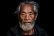 Portrait of an old asian man on a black background.