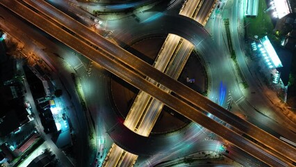 Wall Mural - Expressway top view, Road traffic an important infrastructure, car traffic transportation above intersection road in city night, aerial view cityscape of advanced innovation, financial technology	