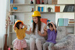 Asian mother and her daughter wearing yellow engineer helmet, education and occupation concept