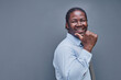 © Katsiaryna - young african american man surprised showing fingers up on gray background