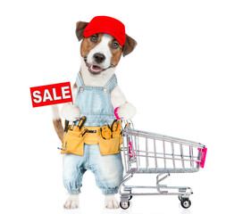 Poster - Funny Jack russell terrier puppy wearing red cap and denim overalls with tool belt pushing the shopping cart and  shows signboard with labeled 