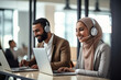 © alisaaa - Two Coworkers Collaborating and Celebrating Their Accomplishment in a Modern Office, Muslim Female Trainer Using Laptop to Onboard a Black Male Customer Support Agent and Answering His Question