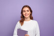 Young woman psychologist smiling looks at the camera isolated on lilac studio background, Copy space