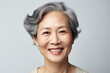 Portrait of an older Asian woman on a white background