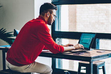 Fototapete - Young male it developer communicating with online customer service from provider 
