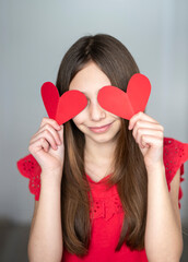 girl holding paper hearts, st.valentines day
