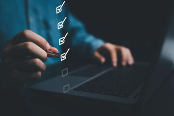 Fototapete - Businessman using pen to tick correct sign mark on virtual checklist for quality control and assurance of ISO concept.