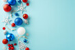 Share your felicitations with this image concept. Top view of colorful trinkets, baubles, holly berries, and snowflake decorations on a pastel blue background, offering space for your text or advert