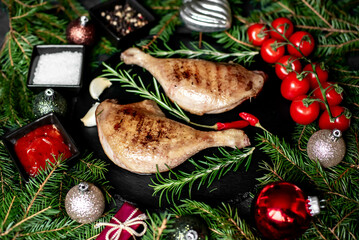 Wall Mural - Christmas grilled duck legs on a background of a Christmas tree and Christmas decorations