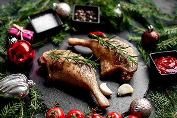 Wall Mural - Christmas grilled duck legs on a background of a Christmas tree and Christmas decorations