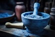 Blue toned close up of pestle and mortar with ground material in lab