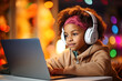 African American boy in headphones remotely learning with laptop, interesting app for children, using modern tech, homeschooling, making homework, clever kid and self education at home concept.
