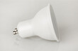 LED light bulb GU10 base, energy-saving energy conservation, isolated on light background