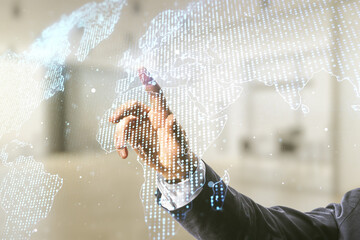 Poster - Man hand working with abstract creative world map interface on blurred office background, international trading concept. Multiexposure