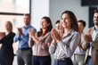 © Laura - A group of employees giving a standing ovation to a colleague, acknowledging their achievements, creativity with copy space
