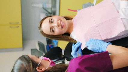 Wall Mural - A dentist drapes a dental napkin over the patient for a clean and comfortable procedure