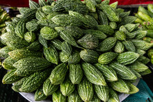 Fresh fruits and vegetables at city market in New Delhi in India. bitter gourd