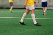 © zphoto83 - Futsal five-a-side players on artificial grass field indoor.