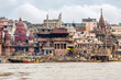 View of the river Ganges with its boats, people and sacred water of Varanasi in India. Manikarnika Ghat