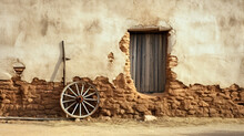 Old Rough Adobe Wall With Window And Wagon Wheel 