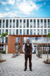 © Vadim - A Glimpse of Urban Life. A man standing in front of a building