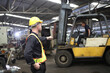 © sittinan - worker or engineer working in factory with safety uniform , safety hat and safety glasses , image is safety concept or happy workplace