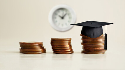 Poster - Invest in Knowledge. Money saving or loan for education abroad concept. Coins stacked graph growing up and graduation hat on wooden table background copy space