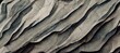 Minimal grey cracked slate stone close up texture, weather erosion chipped shale rock sheets, wavy layered formation geology pattern. 