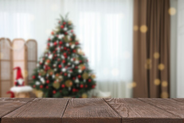 Wall Mural - Wooden table in room decorated for Christmas. Space for design