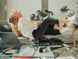 © Westend61 - Cheerful woman having fun listening to music through turntable at home