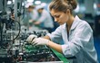 © tongpatong - A female electrical engineer in a white lab coat is performing an optical check on PCB boards while working on an electronic assembly line..