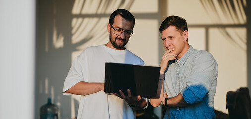 Wall Mural - Portrait of two professional male programmers working on computer in diverse offices. Modern IT technologies, development of artificial intelligence, programs, applications and video games concept